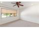 Bedroom with large window, ceiling fan and neutral decor at 6319 N Mockingbird Ln, Paradise Valley, AZ 85253