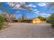 House exterior showcasing a three-car garage and desert landscaping at 6319 N Mockingbird Ln, Paradise Valley, AZ 85253