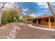 Front yard with mature trees and a stone pathway at 6319 N Mockingbird Ln, Paradise Valley, AZ 85253