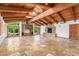 Spacious living room with wood beams and stone fireplace at 6319 N Mockingbird Ln, Paradise Valley, AZ 85253