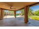 Covered patio with curtains overlooking the pool and backyard at 6319 N Mockingbird Ln, Paradise Valley, AZ 85253