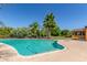 Inviting kidney-shaped pool with a spacious surrounding patio at 6319 N Mockingbird Ln, Paradise Valley, AZ 85253