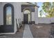 Front entry with walkway, dark gray metal door, and landscaping at 669 S Saddle St, Gilbert, AZ 85233