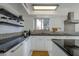 Modern kitchen with white cabinets and black countertops at 669 S Saddle St, Gilbert, AZ 85233