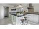 Modern kitchen with island, white cabinets, and granite counters at 669 S Saddle St, Gilbert, AZ 85233