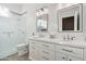 Bright bathroom with double vanity, large mirror, and walk-in shower at 7138 E Laguna Azul Ave, Mesa, AZ 85209