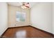 Well-lit bedroom with wood-look flooring and a window at 7138 E Laguna Azul Ave, Mesa, AZ 85209