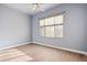 Light and airy bedroom with wood-look floors and window at 7138 E Laguna Azul Ave, Mesa, AZ 85209