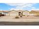 Single-story house with a two-car garage and stone pathway at 7138 E Laguna Azul Ave, Mesa, AZ 85209