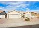 Single-story house with a two-car garage and desert landscaping at 7138 E Laguna Azul Ave, Mesa, AZ 85209