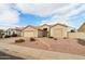 Single story home with landscaped yard and a two-car garage at 7138 E Laguna Azul Ave, Mesa, AZ 85209