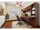 Bright home office with built-in shelves and hardwood floors at 7138 E Laguna Azul Ave, Mesa, AZ 85209