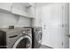 Laundry room with LG washer and dryer, cabinets, and shelving at 7138 E Laguna Azul Ave, Mesa, AZ 85209