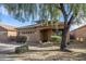 One-story house with tan exterior, two-car garage, and landscaping at 7419 S 31St Dr, Phoenix, AZ 85041