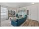 Living room with teal couch, built-in shelving and coffee table at 7419 S 31St Dr, Phoenix, AZ 85041