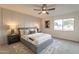 Spacious bedroom with gray bed frame, ceiling fan, and neutral decor at 8413 N 55Th Ave, Glendale, AZ 85302