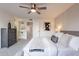 Spacious bedroom with gray platform bed, ceiling fan and dresser at 8413 N 55Th Ave, Glendale, AZ 85302