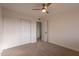 Bright bedroom with double door closet and ceiling fan at 8413 N 55Th Ave, Glendale, AZ 85302