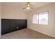 Bedroom with dark accent wall and ceiling fan at 8413 N 55Th Ave, Glendale, AZ 85302