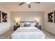 Main bedroom with gray platform bed, ceiling fan, and wood accents at 8413 N 55Th Ave, Glendale, AZ 85302