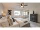 Bright bedroom with gray bed, ceiling fan and mirrored closet doors at 8413 N 55Th Ave, Glendale, AZ 85302