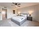 Bedroom with gray bed, ceiling fan, and wood-look floors at 8413 N 55Th Ave, Glendale, AZ 85302