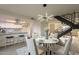 Bright dining area with a round table and four chairs, located near the kitchen and staircase at 8413 N 55Th Ave, Glendale, AZ 85302