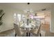 Bright dining area with kitchen view, white table, and four chairs at 8413 N 55Th Ave, Glendale, AZ 85302