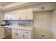 White cabinets, quartz countertops and gray tile backsplash in kitchen at 8413 N 55Th Ave, Glendale, AZ 85302