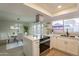 Open concept kitchen with white cabinets, island, and stainless steel appliances at 8413 N 55Th Ave, Glendale, AZ 85302