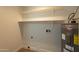 Bright laundry room with shelving and water heater at 8413 N 55Th Ave, Glendale, AZ 85302