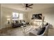 Living room with gray sofa, gold accents, and a TV at 8413 N 55Th Ave, Glendale, AZ 85302