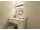 Modern bathroom vanity with a round mirror and marble countertop at 8413 N 55Th Ave, Glendale, AZ 85302