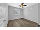 Bright bedroom featuring wood-look floors and ceiling fan at 955 E Knox Rd # 110, Chandler, AZ 85225