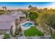 Aerial view of a beautiful home with a large pool and lush landscaping at 9690 N 117Th Way, Scottsdale, AZ 85259