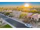 Aerial view of house and neighborhood with a sunset at 9690 N 117Th Way, Scottsdale, AZ 85259