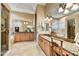 Elegant bathroom with double sinks, granite countertop, and a large soaking tub at 9690 N 117Th Way, Scottsdale, AZ 85259