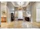 Spacious entryway with tiled floors, chandelier, and built-in shelving at 9690 N 117Th Way, Scottsdale, AZ 85259