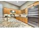 Modern kitchen features stainless steel appliances and granite countertops at 9690 N 117Th Way, Scottsdale, AZ 85259