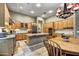 Kitchen boasts granite countertops, wood cabinets, and an island with seating at 9690 N 117Th Way, Scottsdale, AZ 85259