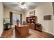 Home office with wood desk, built in shelving, and hardwood floors at 9690 N 117Th Way, Scottsdale, AZ 85259