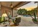 Relaxing patio with seating area and views of the pool and sunset at 9690 N 117Th Way, Scottsdale, AZ 85259