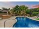 Beautiful blue swimming pool with a spacious patio and a waterfall feature at 9690 N 117Th Way, Scottsdale, AZ 85259