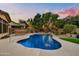 Stunning kidney-shaped pool with a large patio and outdoor kitchen at 9690 N 117Th Way, Scottsdale, AZ 85259