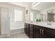 Bathroom with double vanity, soaking tub, and shower at 10031 E Gamma Ave, Mesa, AZ 85212