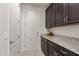 Laundry room with granite countertop and dark cabinets at 10031 E Gamma Ave, Mesa, AZ 85212