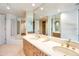 Modern bathroom with double sinks, a large mirror, and a corner bathtub at 10040 E Happy Valley Rd # 1047, Scottsdale, AZ 85255