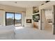 Spacious bedroom with fireplace, large TV, and balcony access at 10040 E Happy Valley Rd # 1047, Scottsdale, AZ 85255