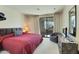 Spacious bedroom with a king-size bed, patio access, and built-in entertainment center at 10040 E Happy Valley Rd # 1047, Scottsdale, AZ 85255