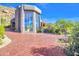 Brick driveway leading to a contemporary home with large windows at 10040 E Happy Valley Rd # 1047, Scottsdale, AZ 85255